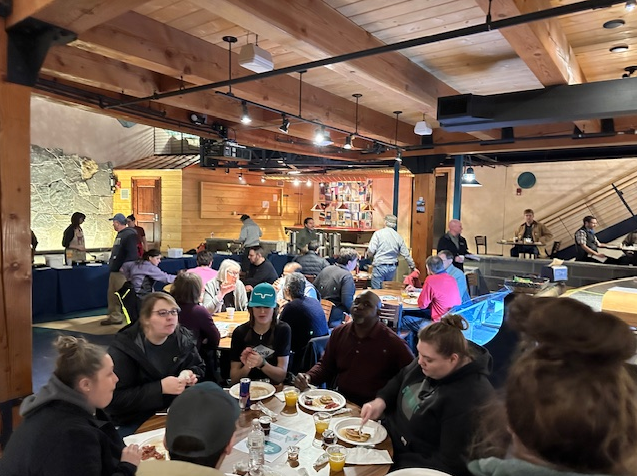 Photos of staff members eating pancakes