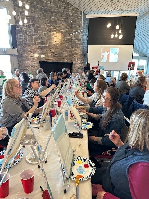 Shot of several participants in the process of painting