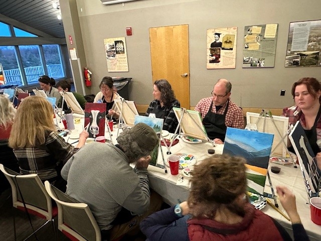 Shot of several participants in the process of painting
