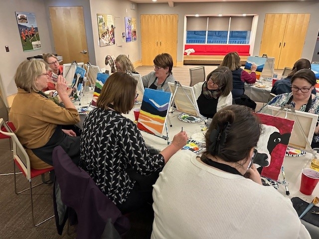 Shot of several participants in the process of painting