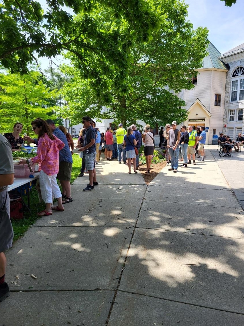 Employees at a bbq getting food