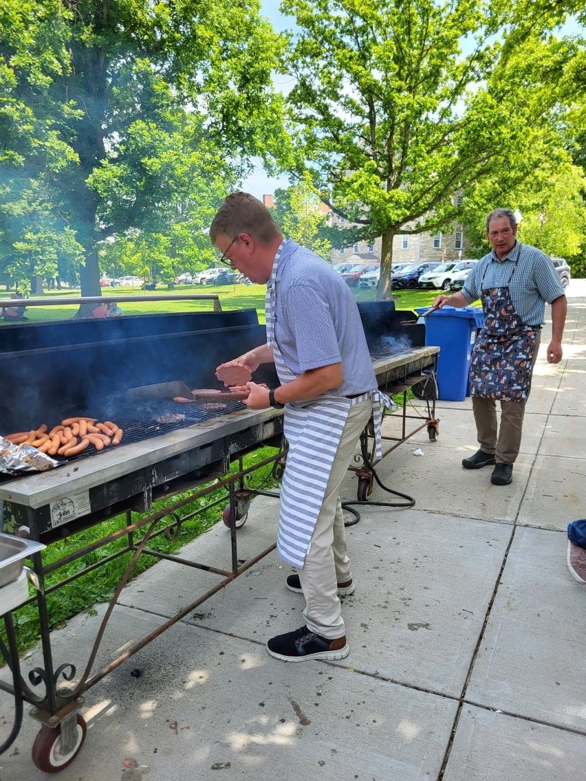 Employees cooking on the grille wearing aprons