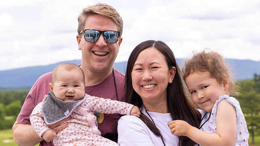 A class of 2009 family all smiles, including the toddler and the baby