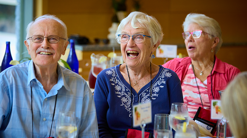 A trio of 1959 classmates share a laugh