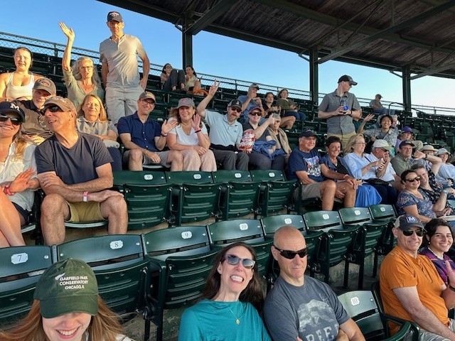 Group of Middlebury Employees sitting in the stands at Centennial Field waiting for the game to start. 