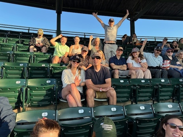 Group of Middlebury Employees sitting in the stands at Centennial Field waiting for the game to start. 