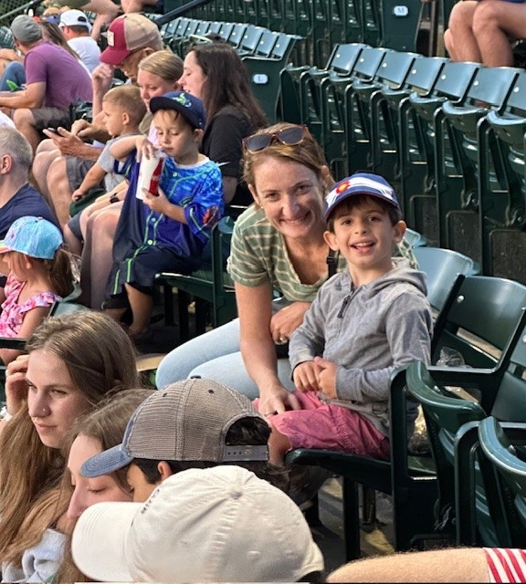 A Mom and Son enjoying the game together smiling. 