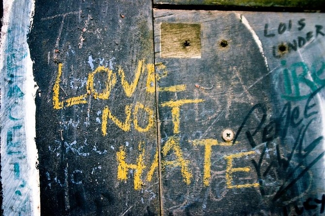 The words "Love Not Hate" in graffiti writte on grey wall