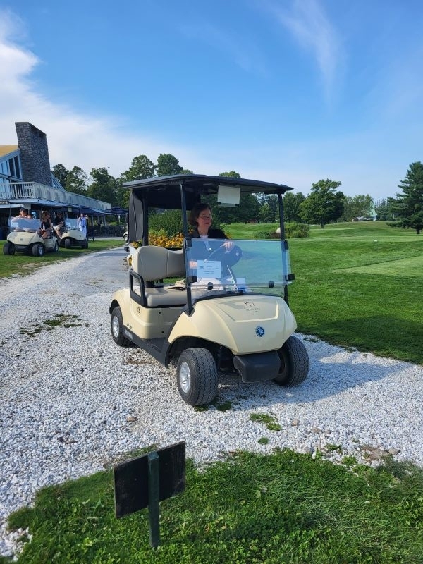 Employee Driving Golf Cart