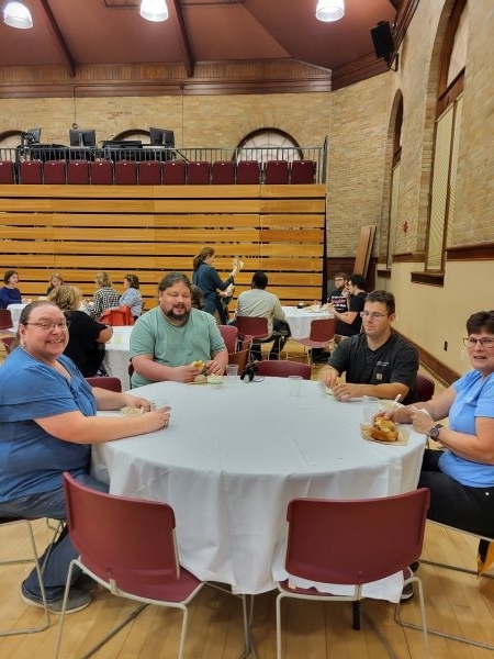 Employees sitting eating grilled cheese