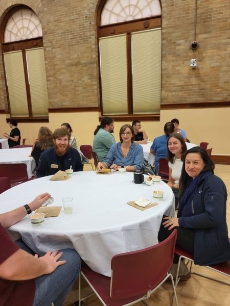 Employees sitting eating grilled cheese