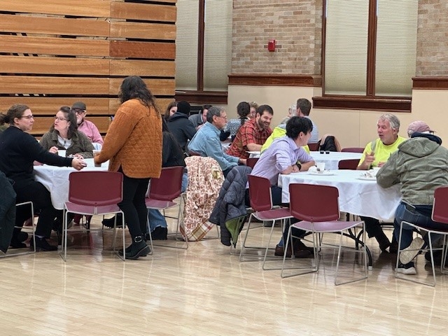 Colleagues sitting together eating breakfast and talking
