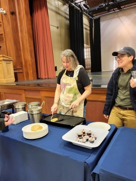 Employees talking cooking pancakes