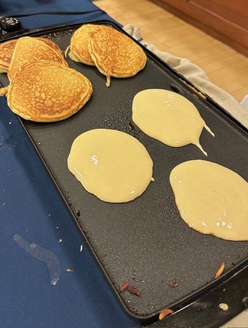 Pancakes cooking on a gridle