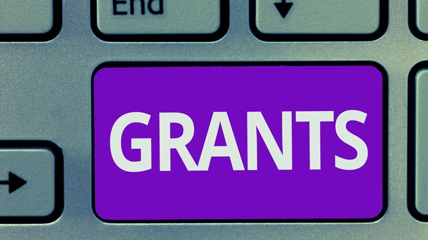 Images of a keyboard with the word Grants in large letters.