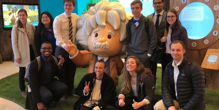 Middlebury students posing with the Einstein statue at Salesforce during the Student Trek