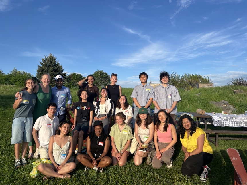 A group of 17 people are pictured smiling out at the Knoll.
