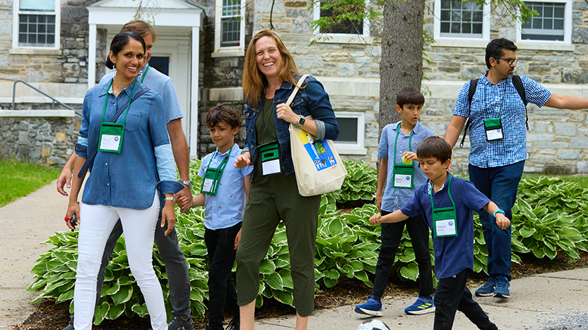 Classmates from 2005 mid-walk with elementary-aged children and spouses