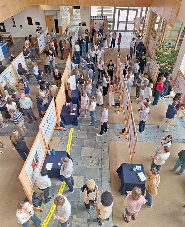 Large hall with poster boards and people