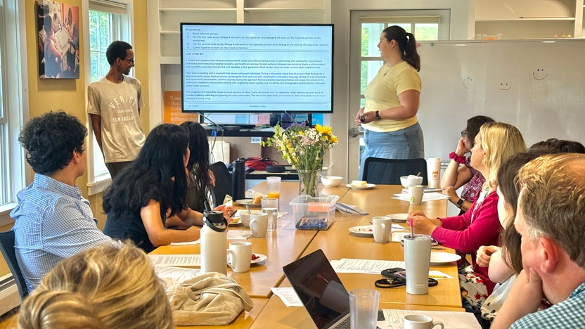 A group around a table discussing a presentation.