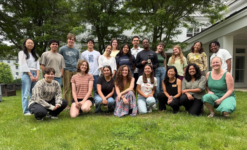 Group of SSL, Knoll, and SEA staff smile at the camera in a group in the Hillcrest courtyard