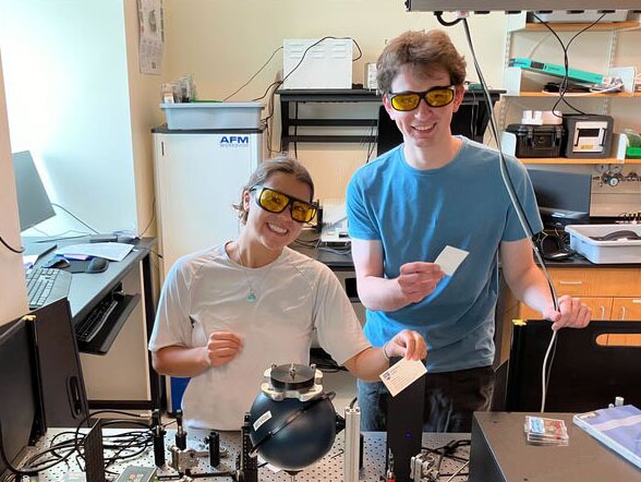 Two students in a lab wearing safety googles