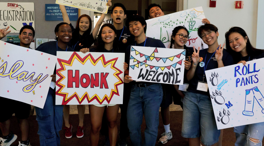 welcome to new students with signs