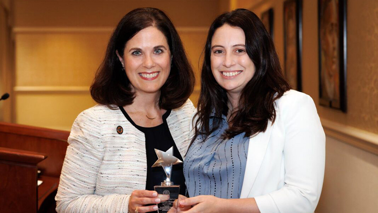 Katherine Roseau, MA French ’12 posing for a picture with award.