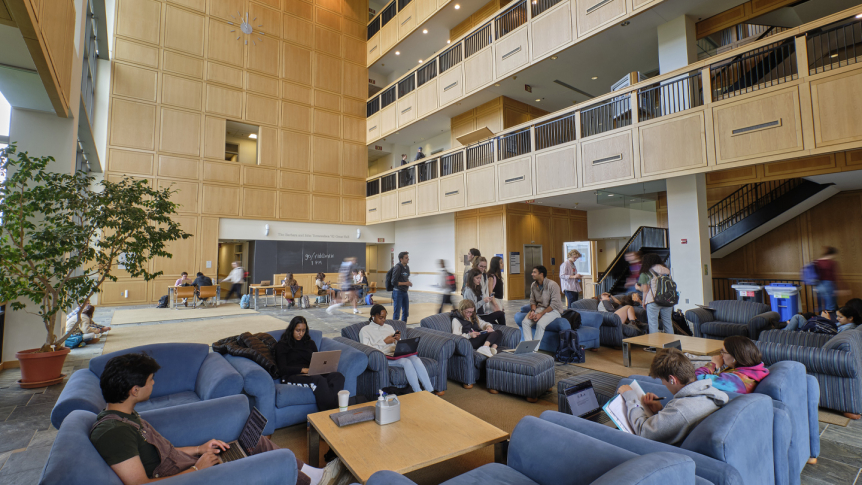 Students in the center seating area of Bi Hall during a class change.