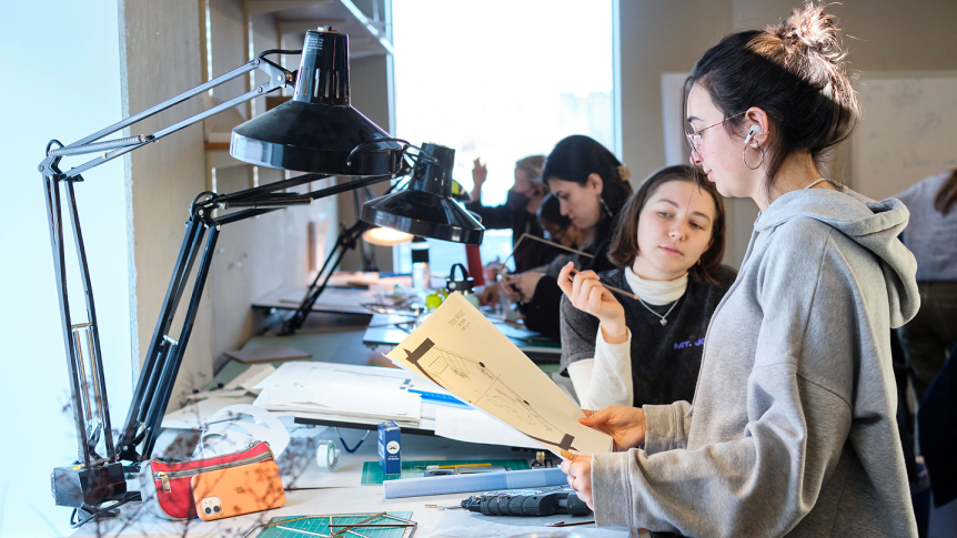 Students share architectural sketches during class.