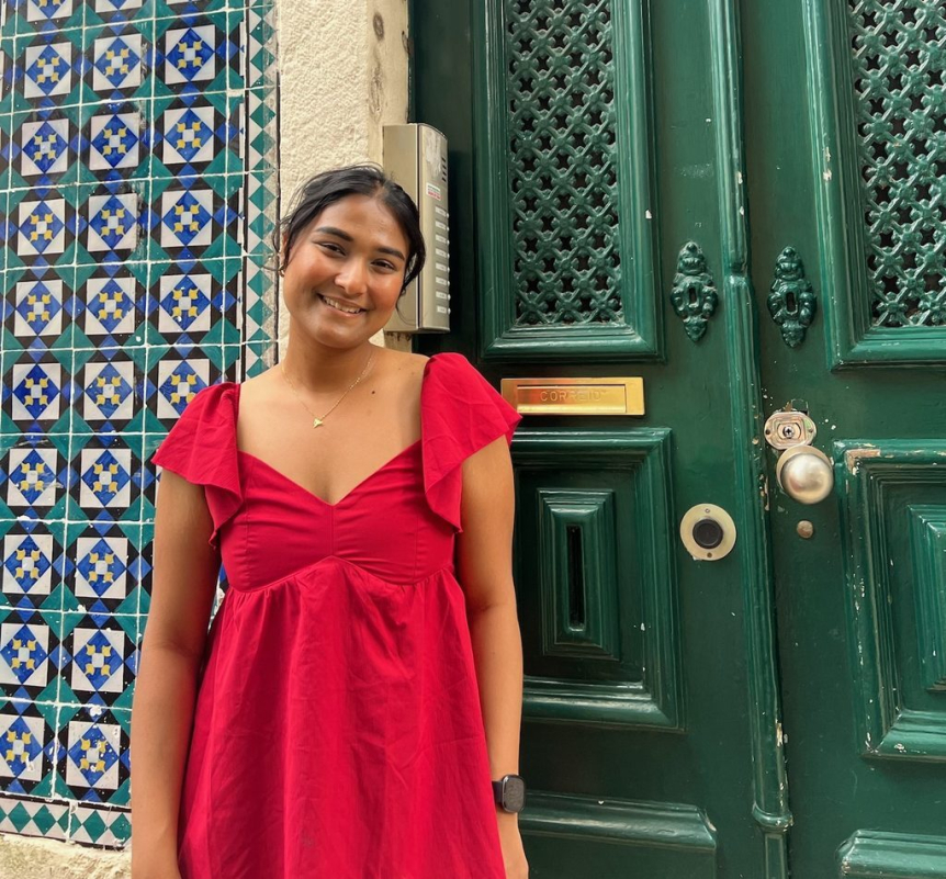 A person standing outside smiles at the camera.