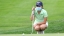A Middlebury golf player looks at a putt during practice.