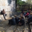 students seated on stone steps participating in discussion