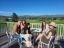 Five colleagues sitting together enjoying the sun overlooking the golf course and mountains