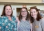 Three colleagues standing together Smiling