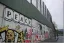 photo of city wall with the word PEACE and images of conflict