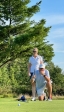 Colleagues standing together playing golf