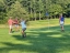 Colleagues standing together playing golf
