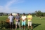 Colleagues standing together playing golf