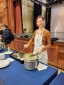 Employee smiling adding more pancake to the gridle