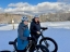 Photo of two employees on bikes in the snow