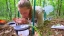 Student conducting tick research on forest floor