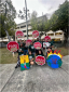 Group of students holding climate justice protest signs shaped like stop signs