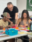 Two students work on artivism projects with the help of Efren Olson Sanchez