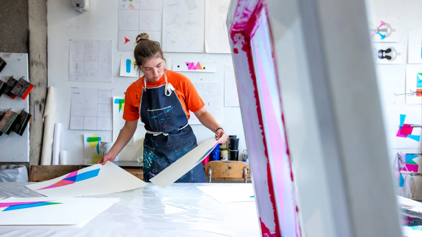 Two students work on a complex navigating system on a boat.