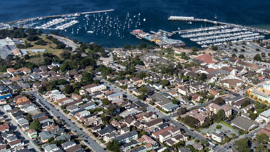 The Chateau in the summer with three people walking towards it and a mountain in the distance.