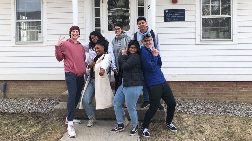 Student workers pose outside of Chellis House on campus.