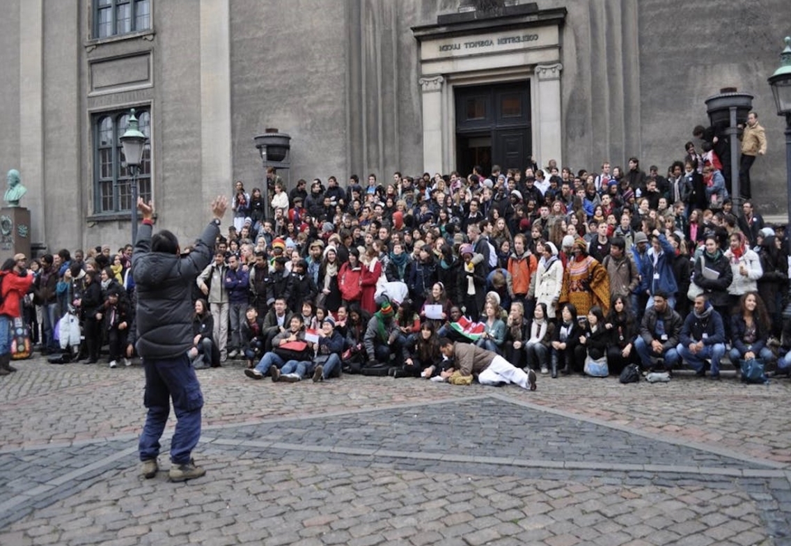 a group of students, professors, and delegates that attended COP26 post for a photo