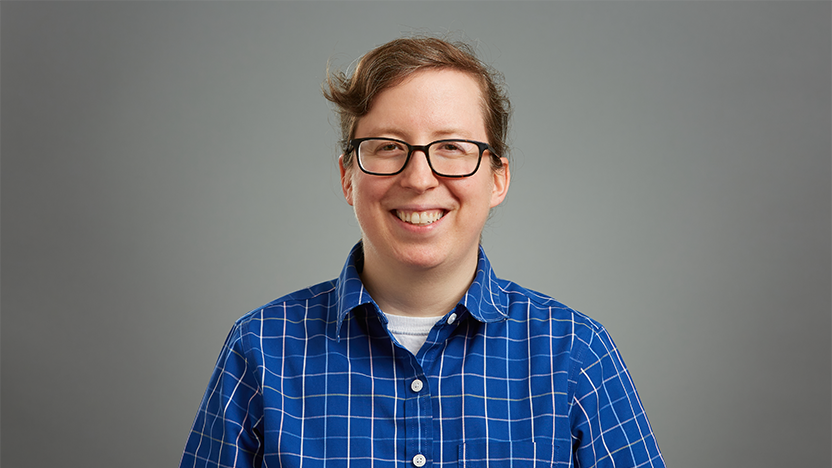 Amanda Gregg in a blue and white-striped collared shirt