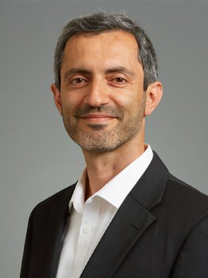 Ata Anzali in dark suit with white shirt